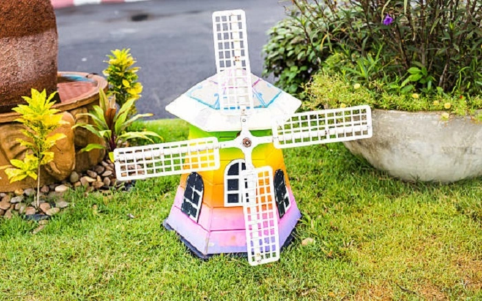 image of a small decorative windmill in a lawn