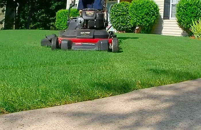 image of mowing bermuda grass lawn