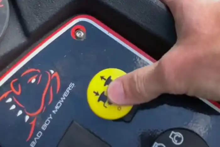 image of turning on the safety features of a zero turn bad boy mower